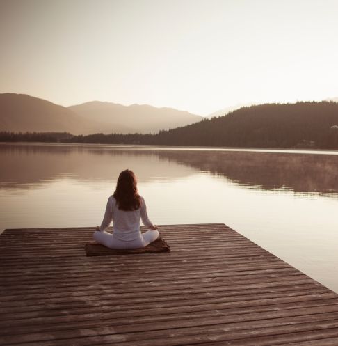 About Page-2 Woman sitting on a dock meditating
