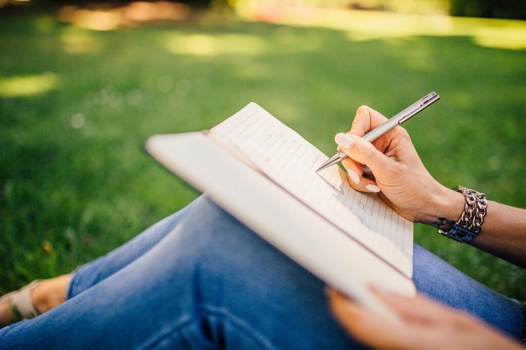 writing, writer, notes, pen, notebook, book, girl, woman, people, hands, nature, grass, outdoors
